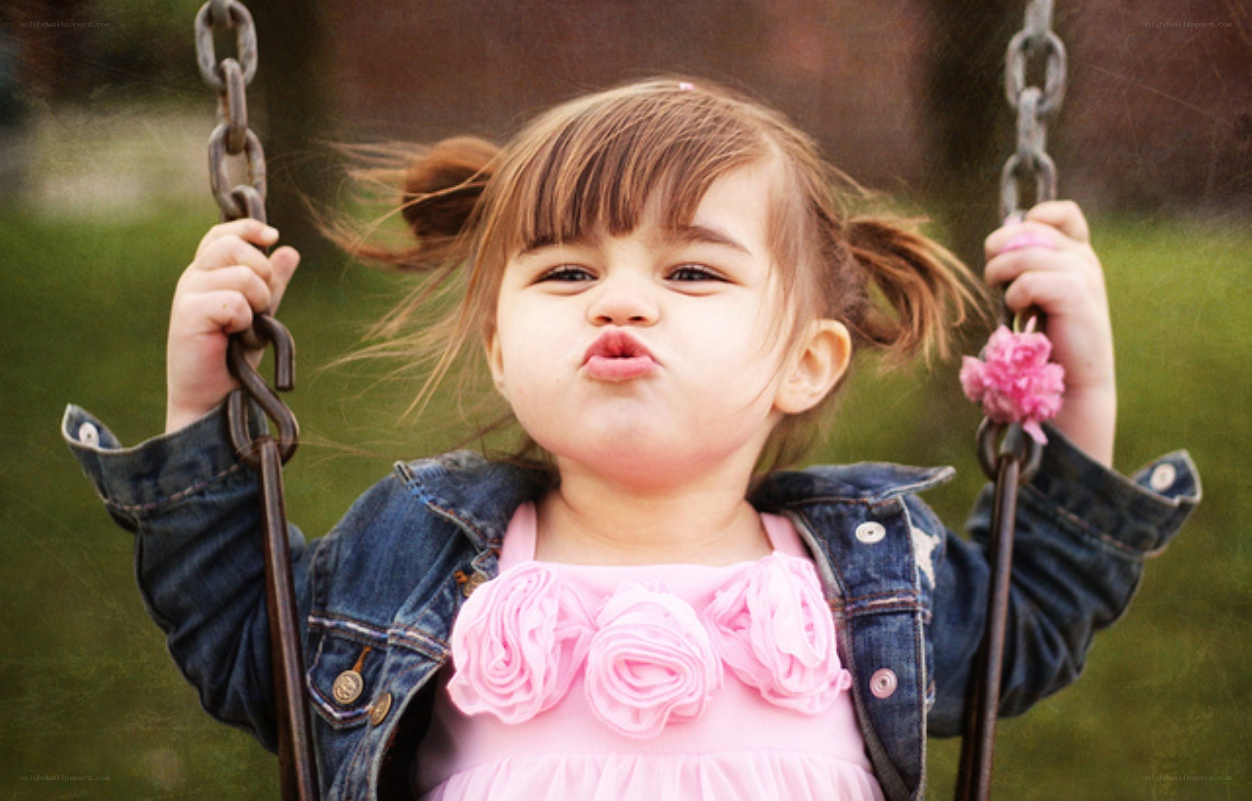 child on a swing making a face