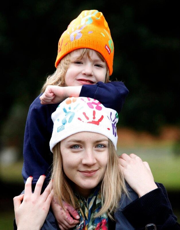 child on adult's shoulders