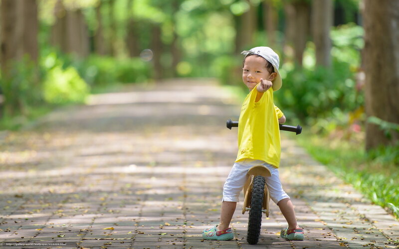 child on balance bike in park