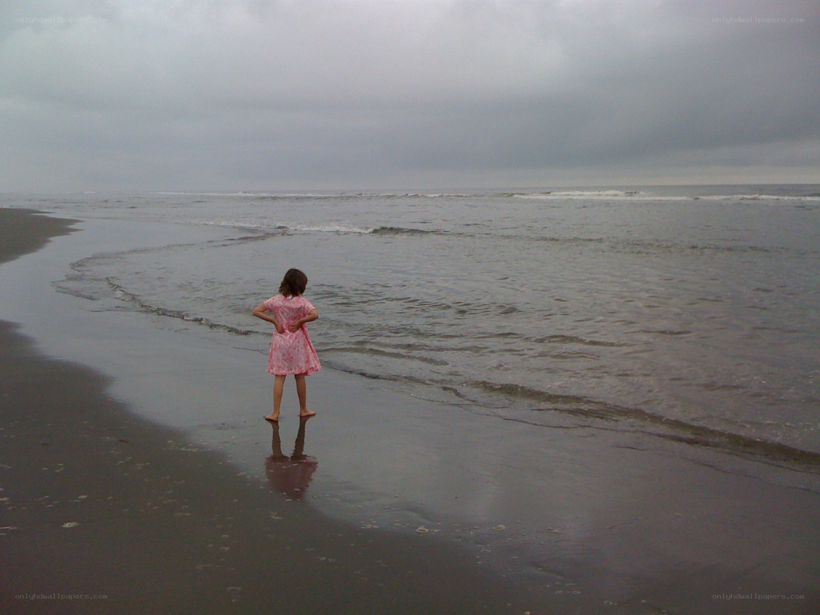 child on beach at low tide