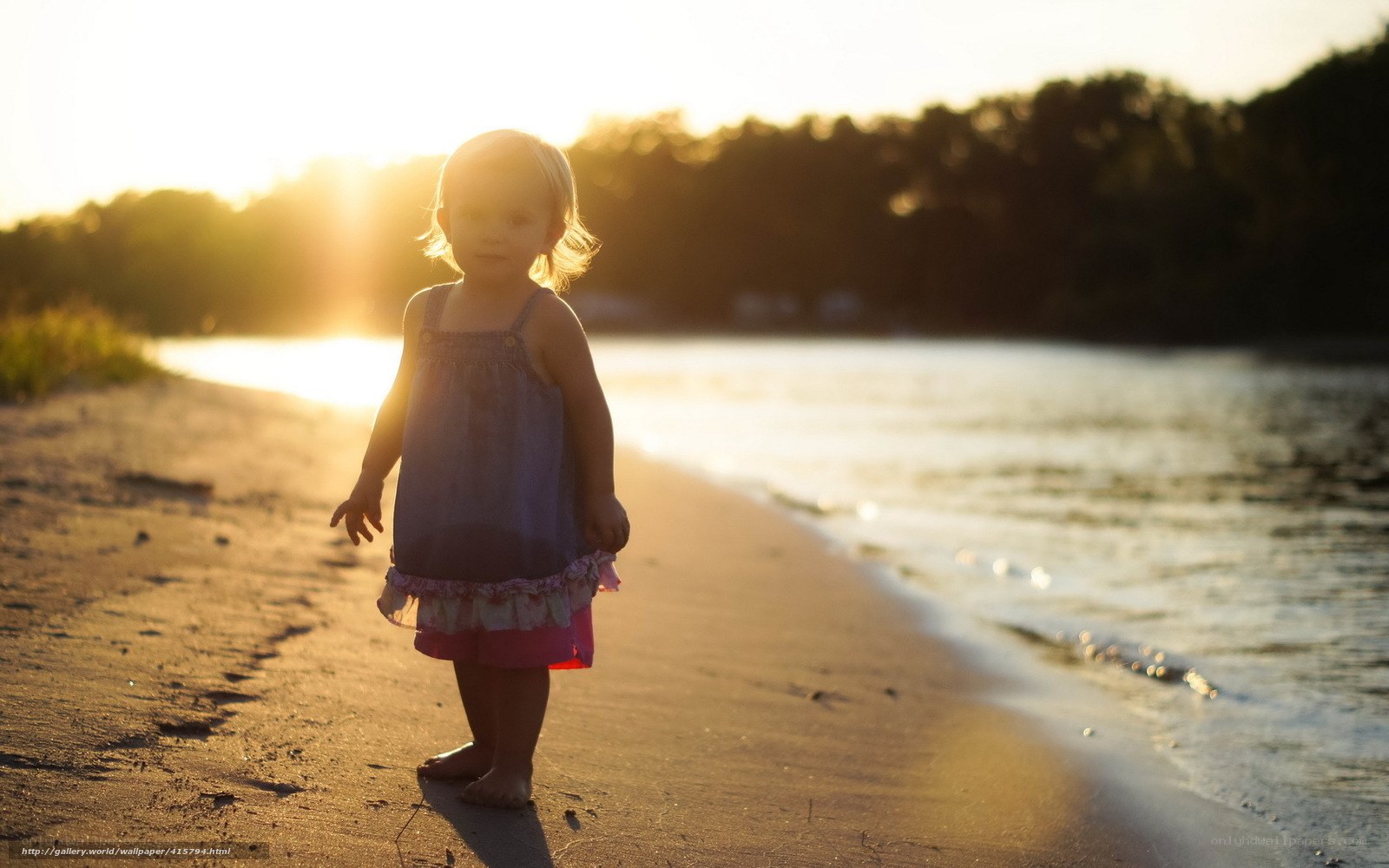 child on beach at sunset
