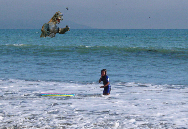 Child on Beach with Dinosaur