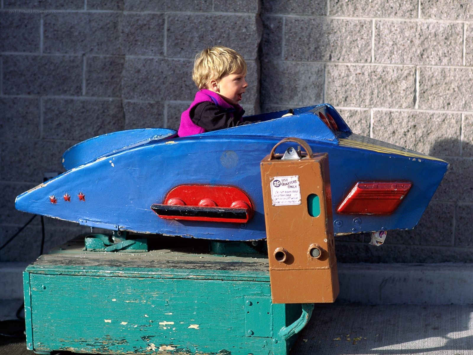child on blue ride