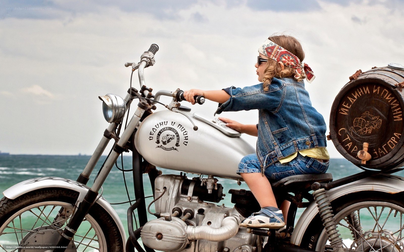 child on motorcycle by sea