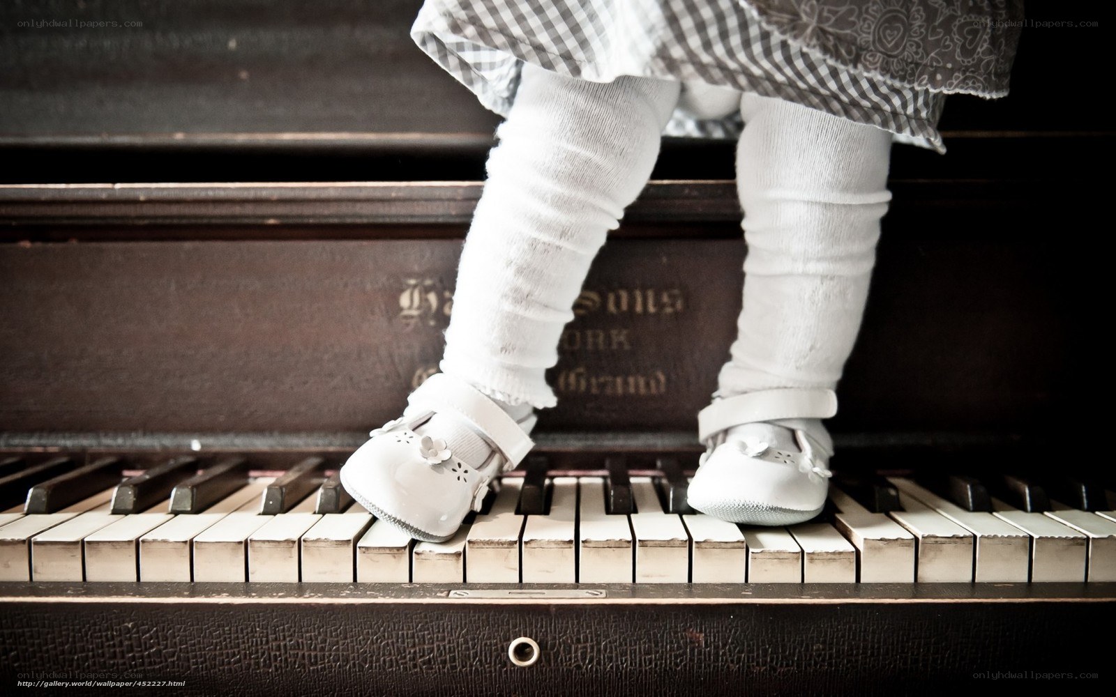 child on piano keys