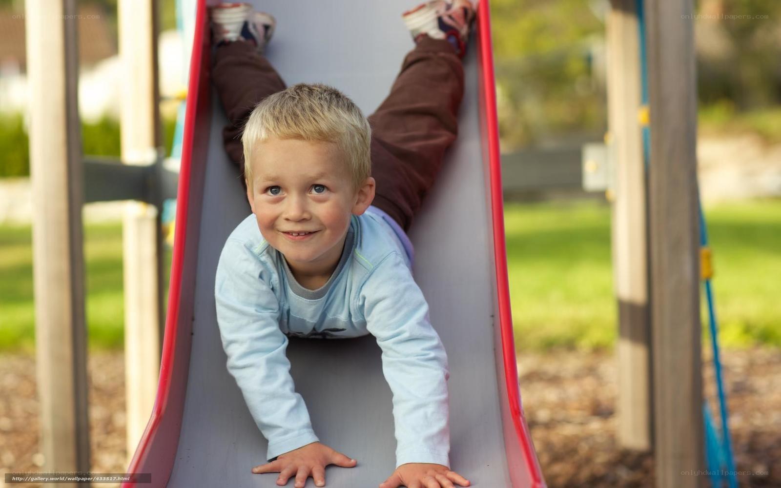 child on playground slide