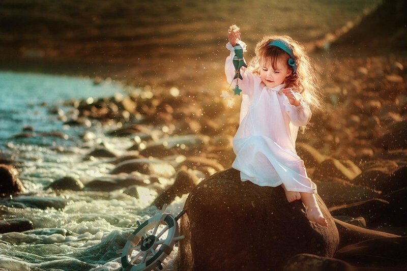 Child on Rock at Shore