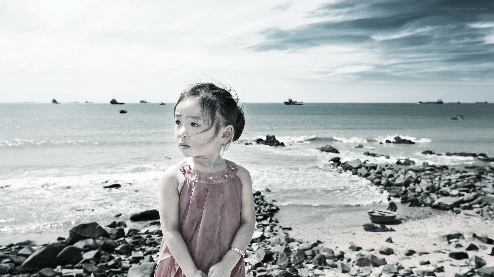 child on rocky beach