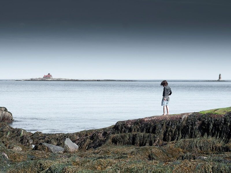 Child on Rocky Shore — Gray