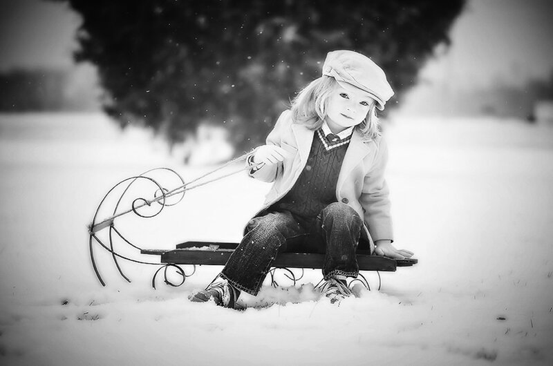 Child on Sled in Snow — Black