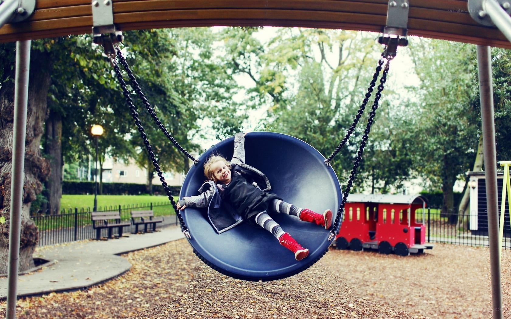 child on swing in park