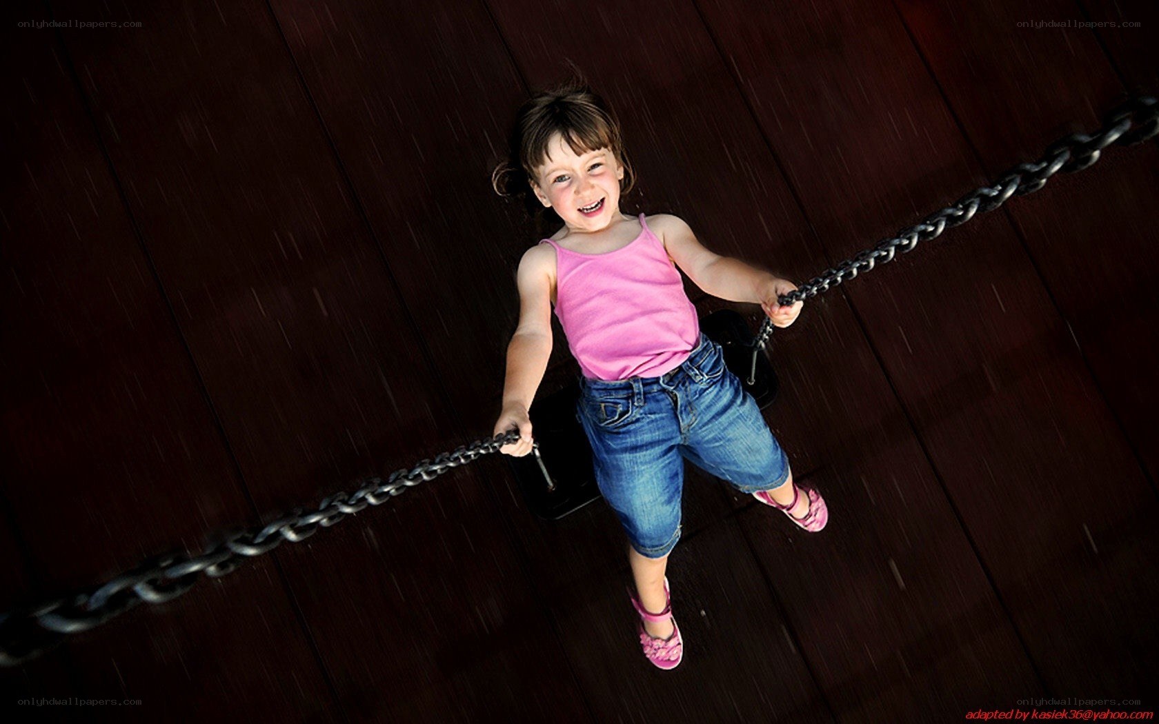 child on swing in rain