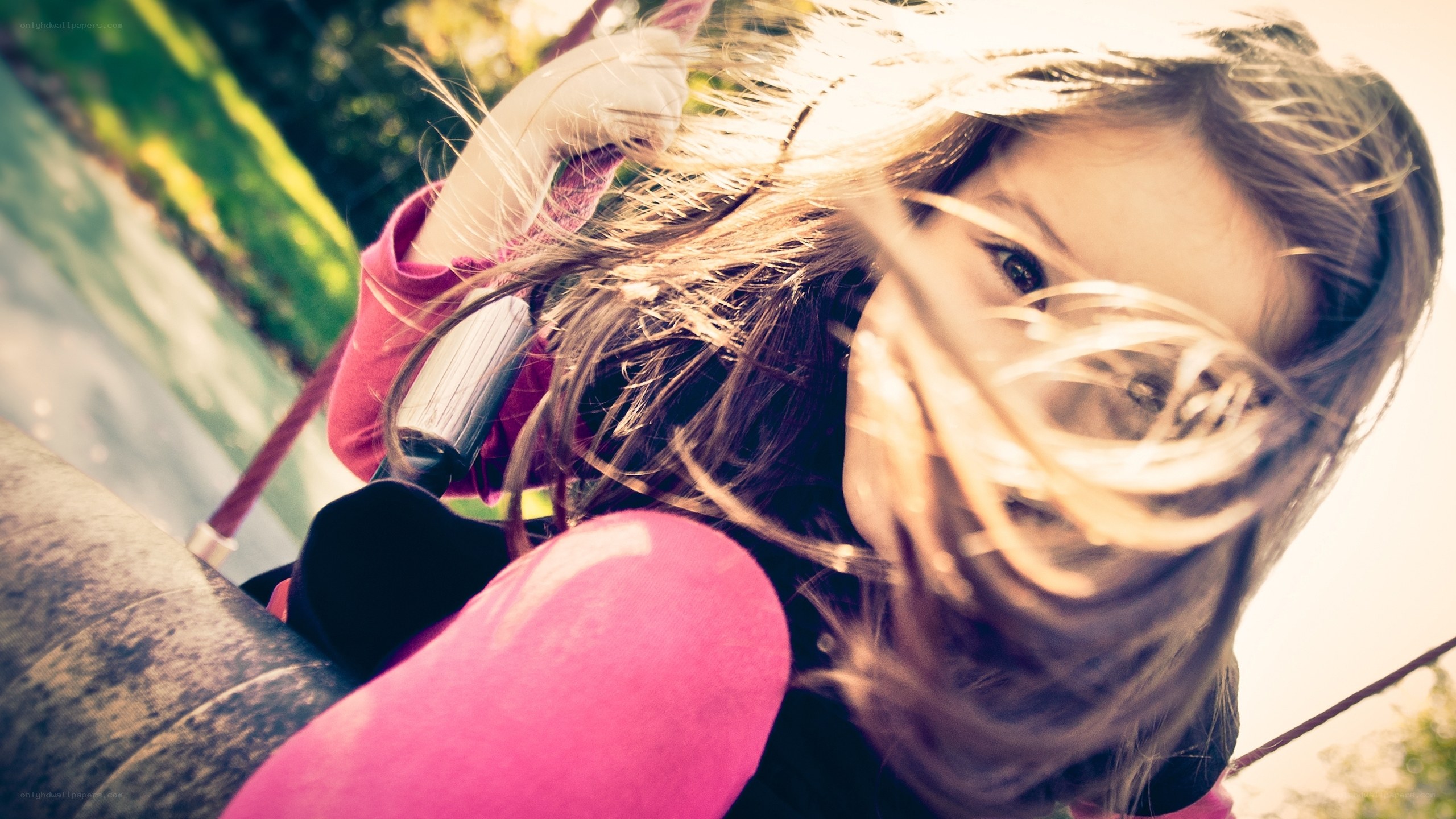 child on swing in sunlight