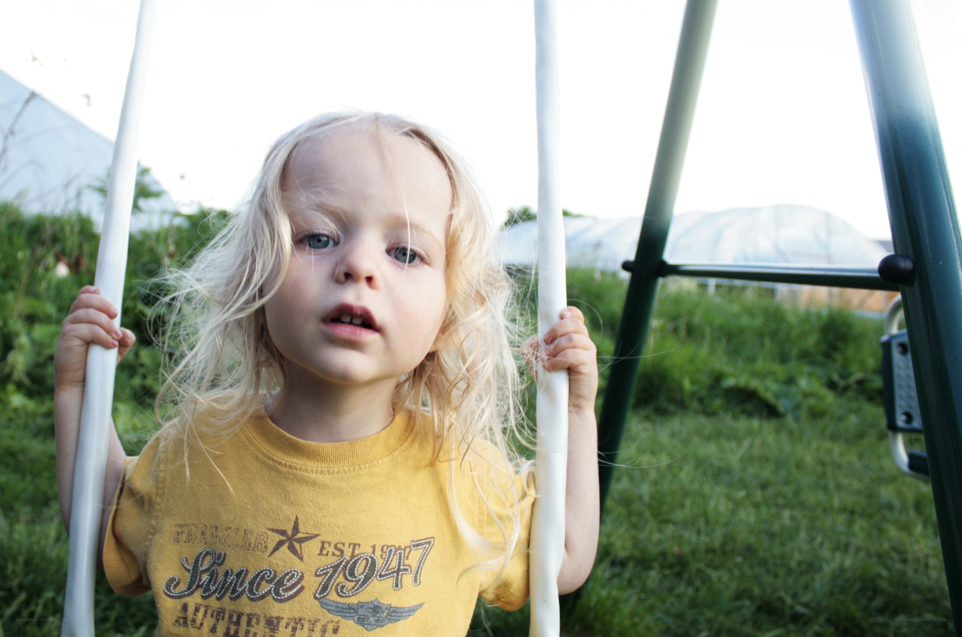 child on swing outdoors