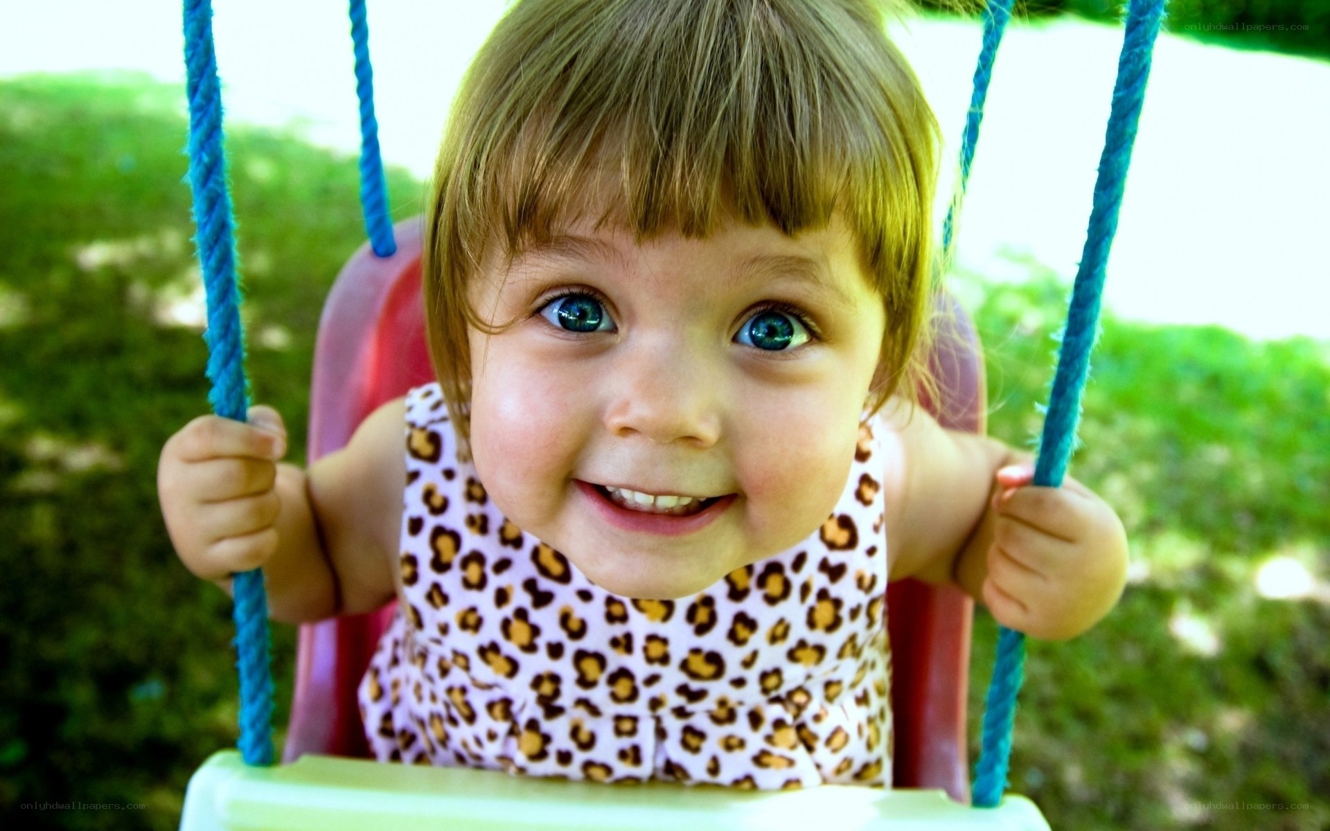 child on swing smiling