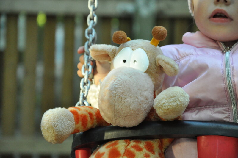 Child on Swing with Giraffe