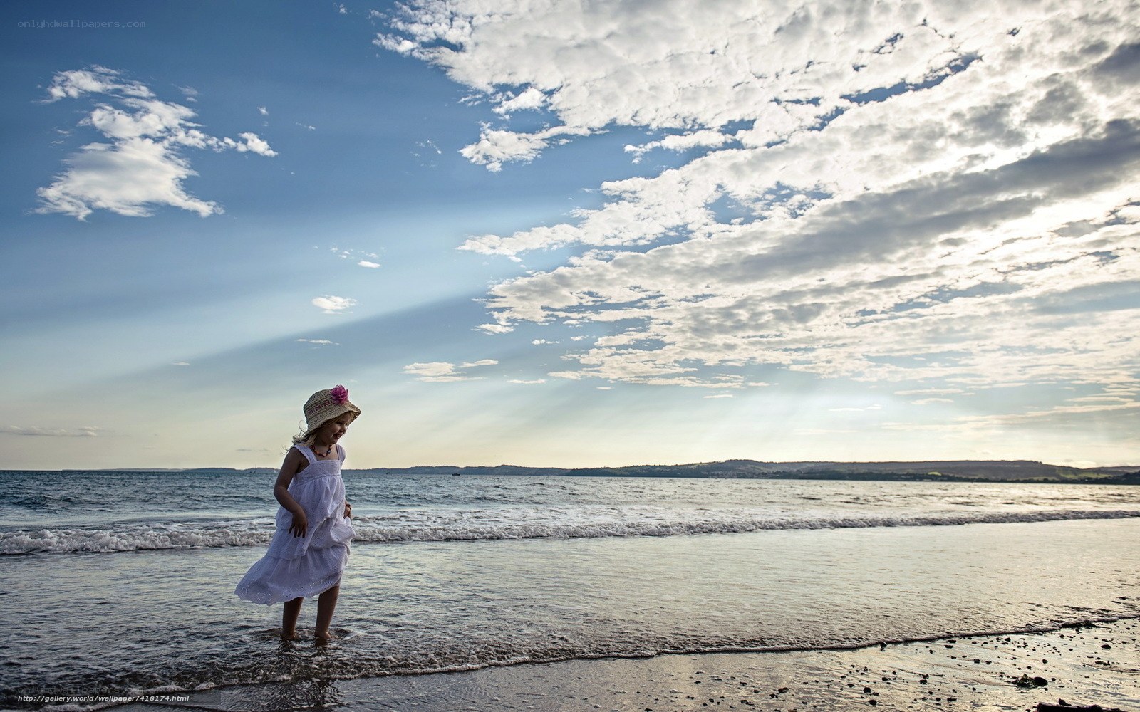 Child on the beach at sunset