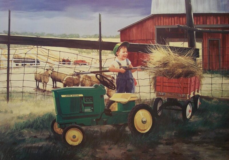 Child on tractor with hay