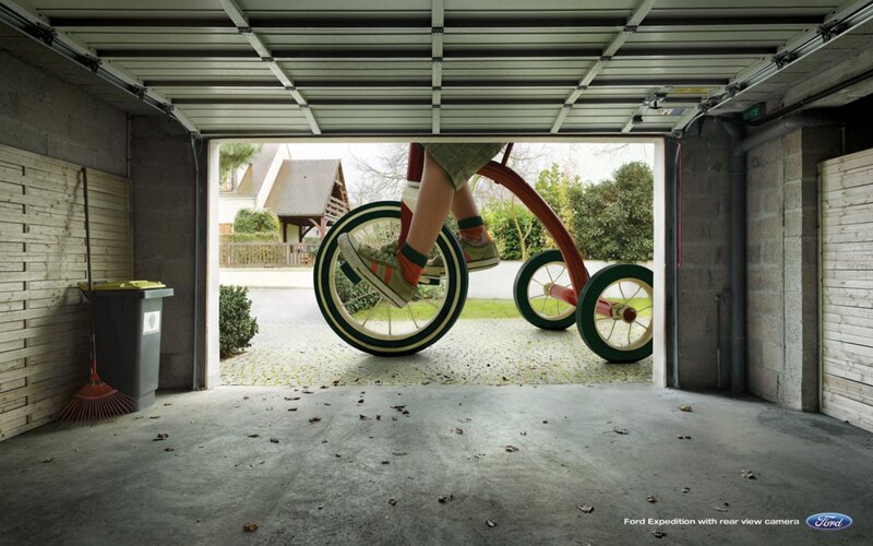 Child on tricycle in garage