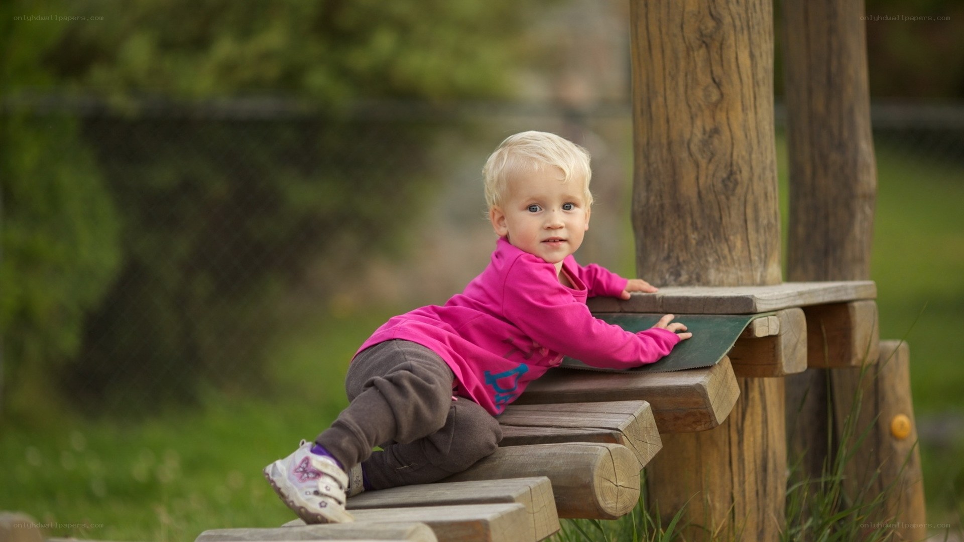 child on wooden play structure