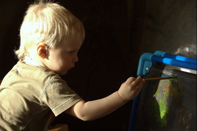 Child Painting on Easel