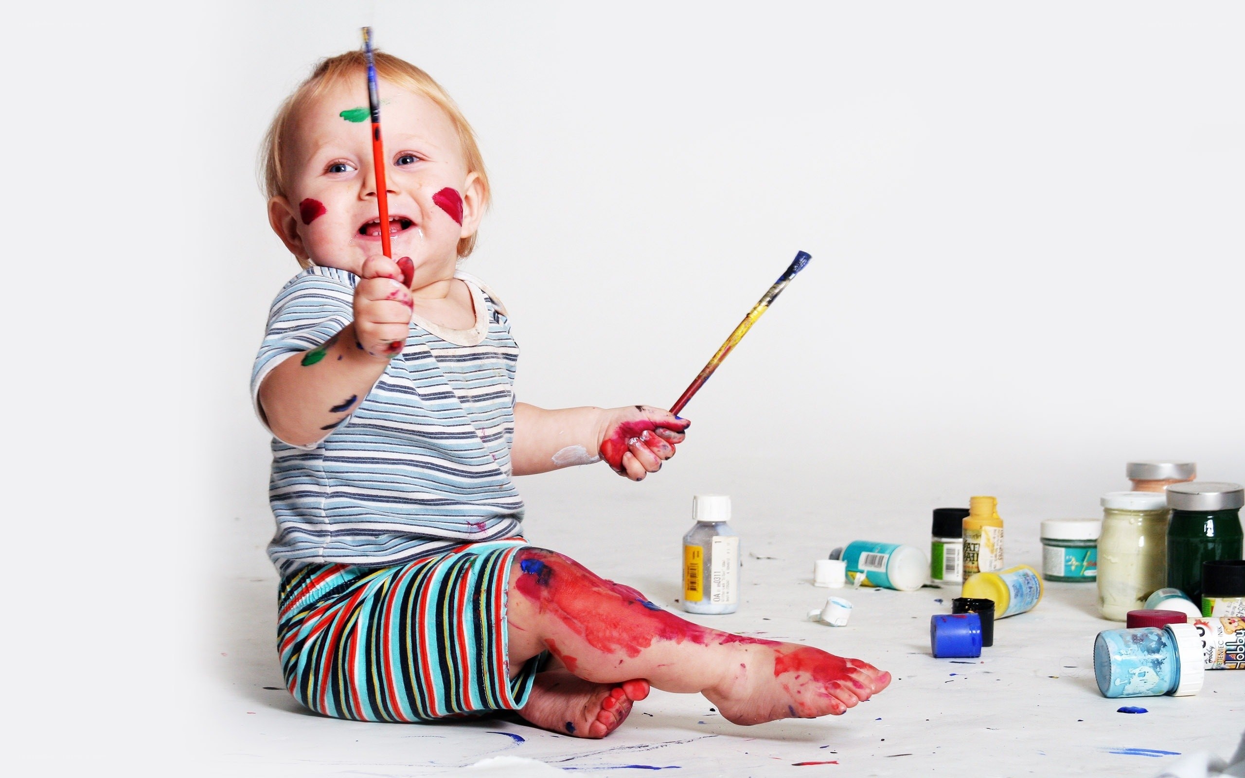 child painting with colorful paint