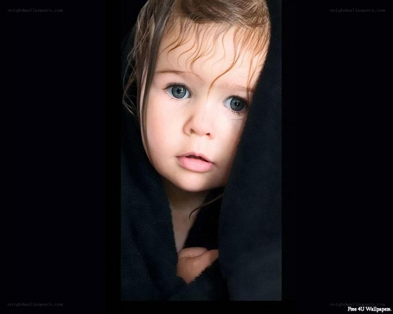 child peeking from behind fabric