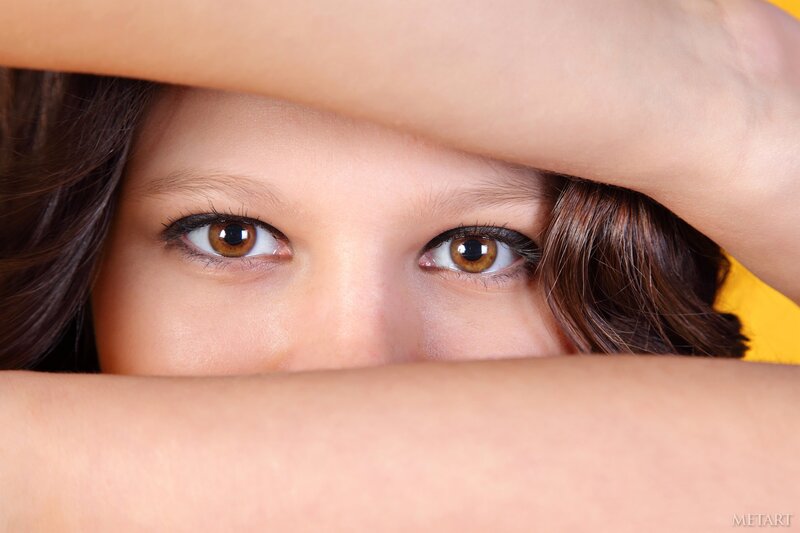 Child Peeking from Behind Hands