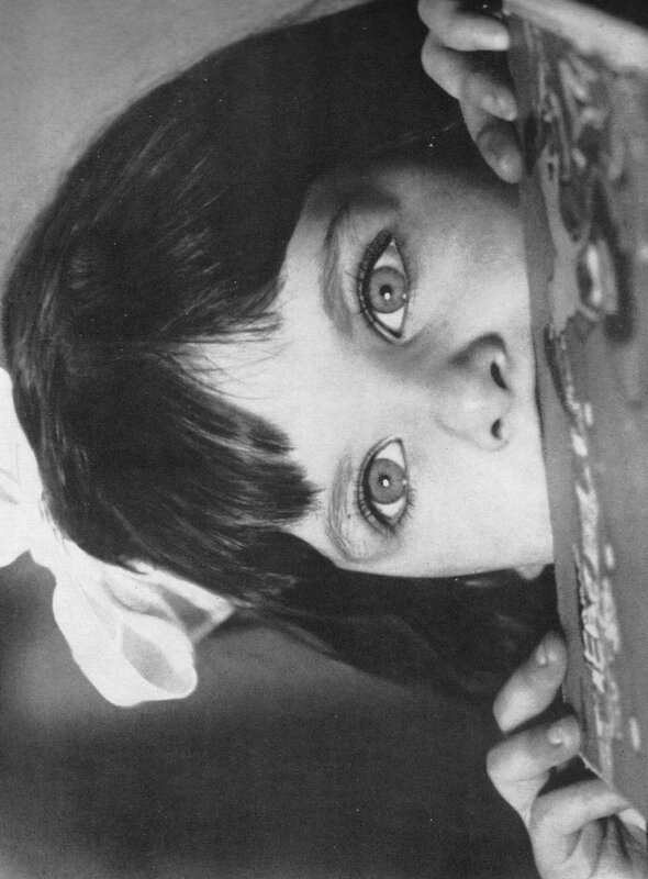 child peeking from behind object