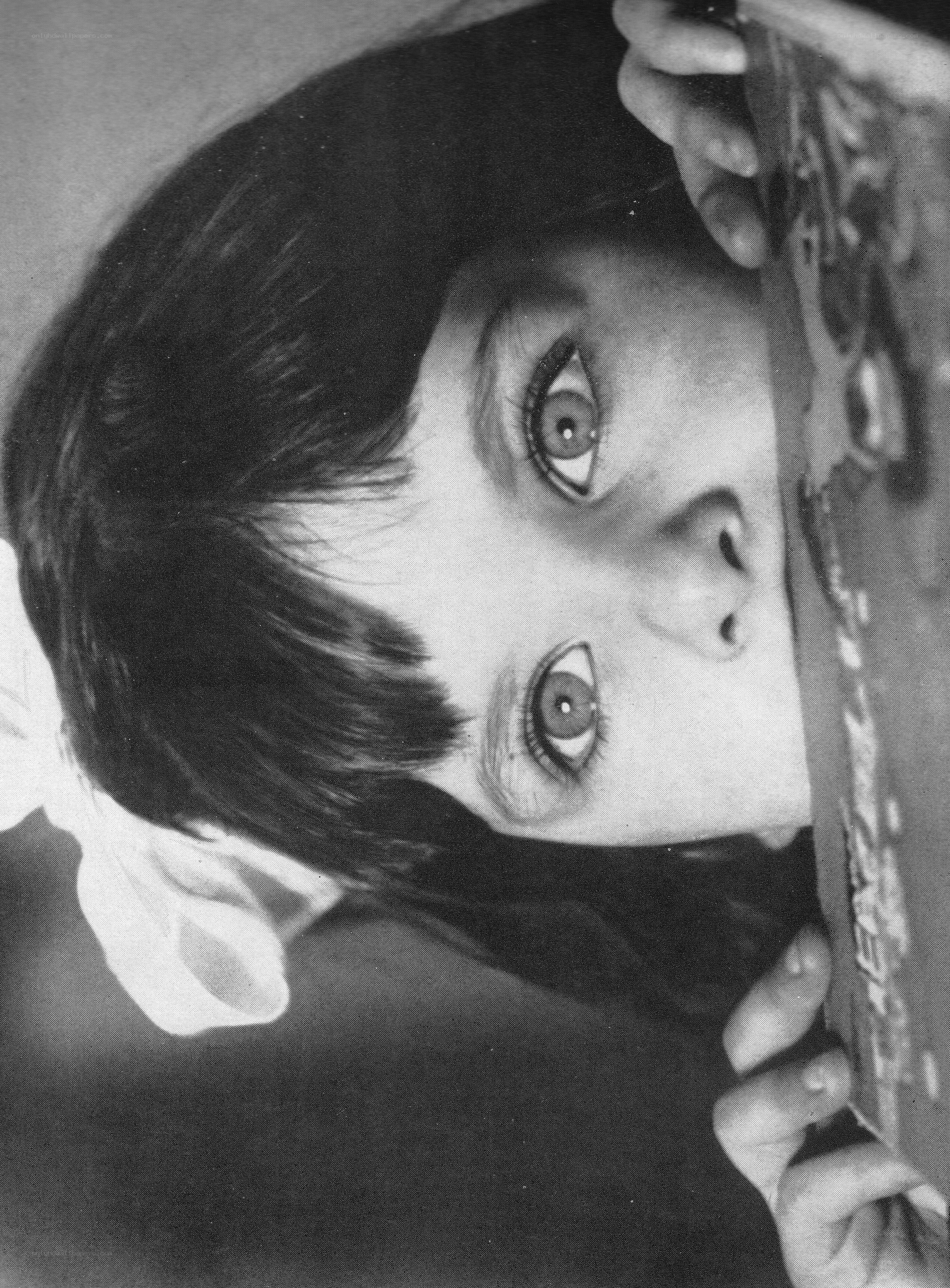 child peeking from behind object