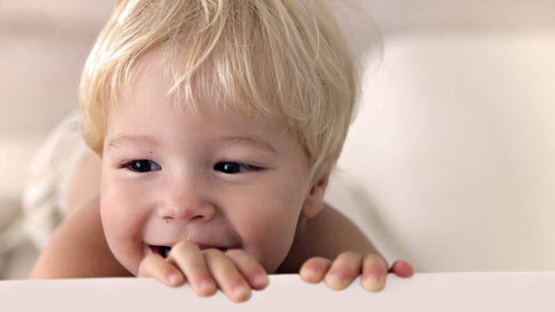 child peeking over a surface