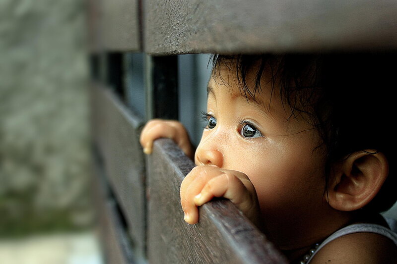 Child Peeking over Railing