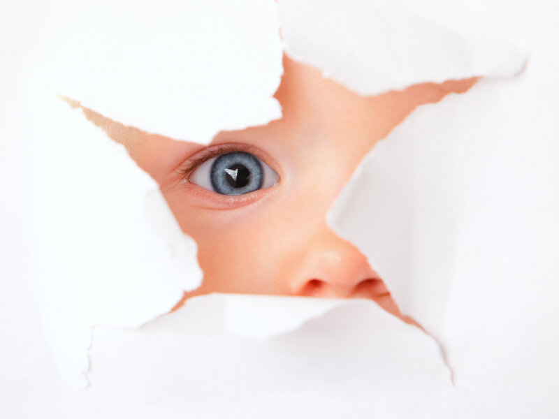 Child Peeking Through Paper — White