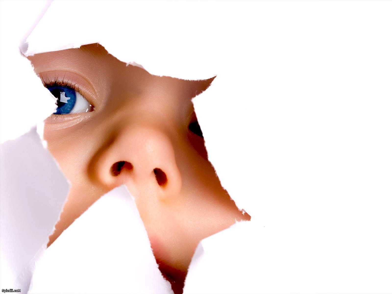 child peeking through torn paper