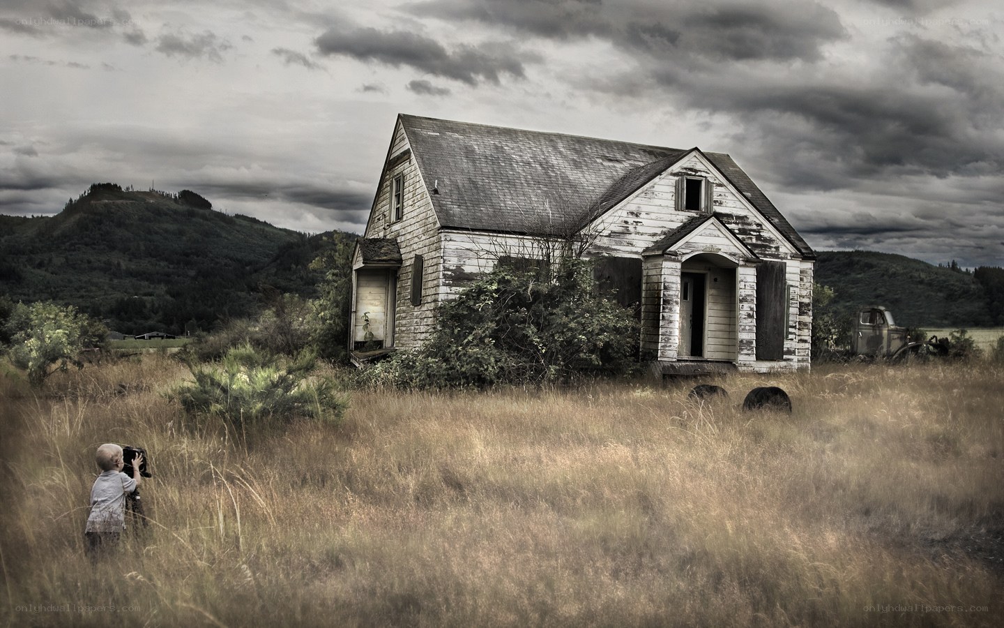 Child photographing old house