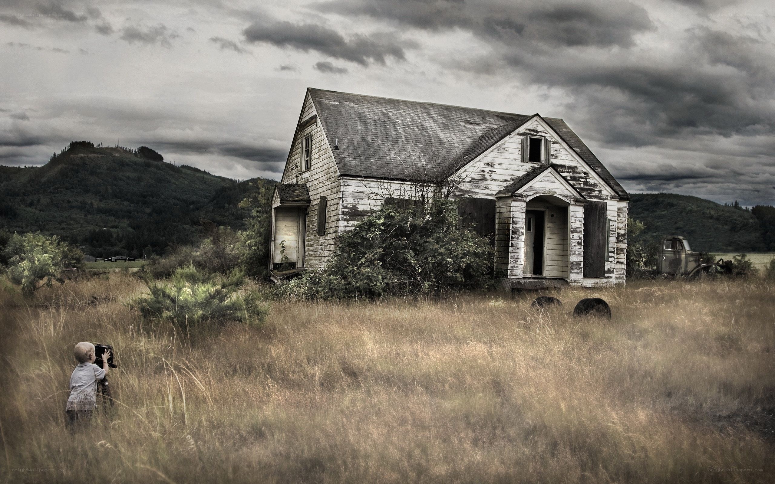 Child photographing old house
