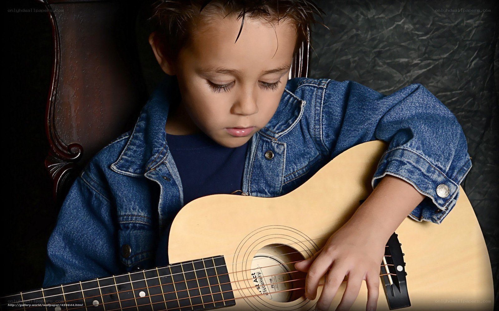child playing acoustic guitar
