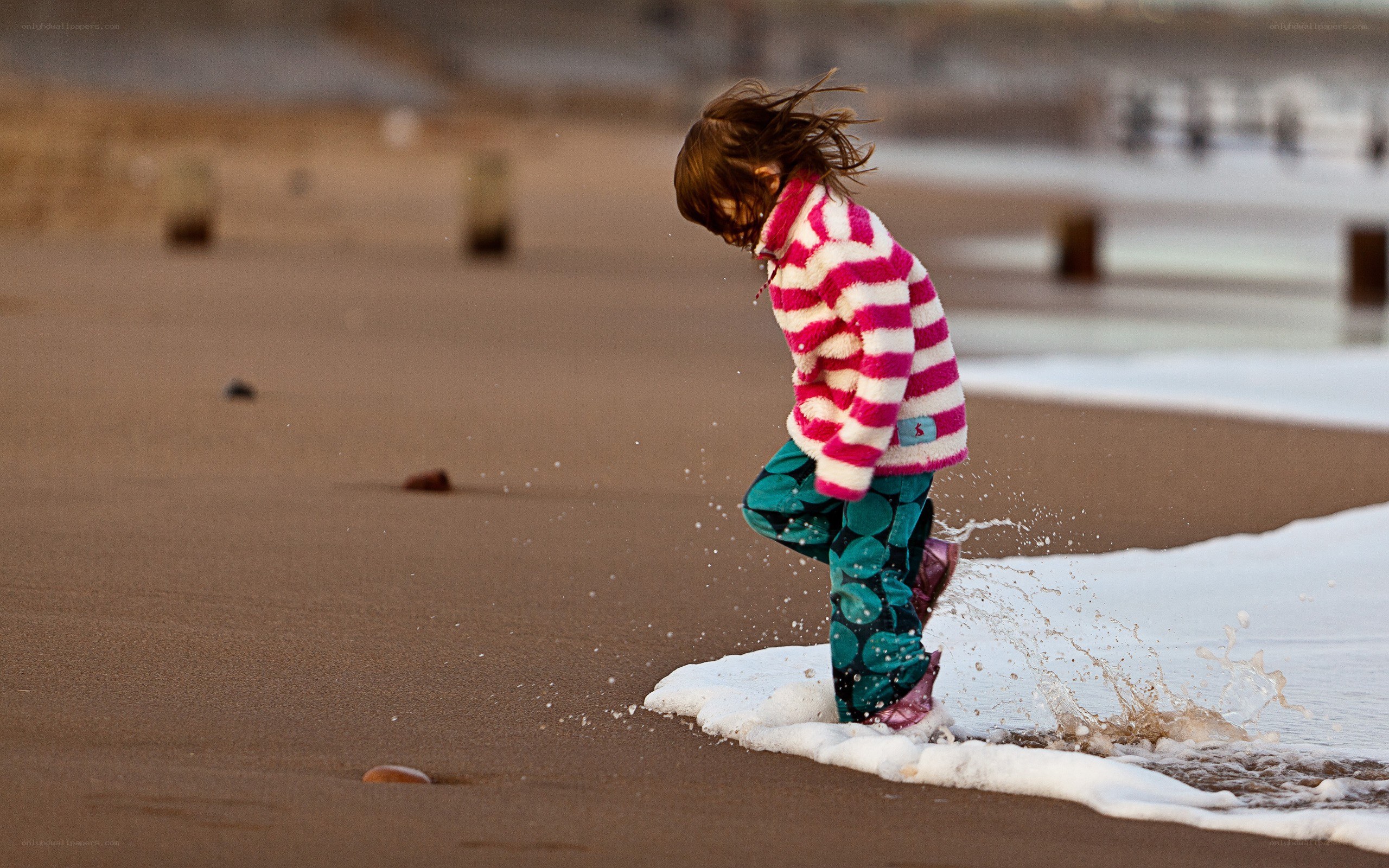 child playing at the beach