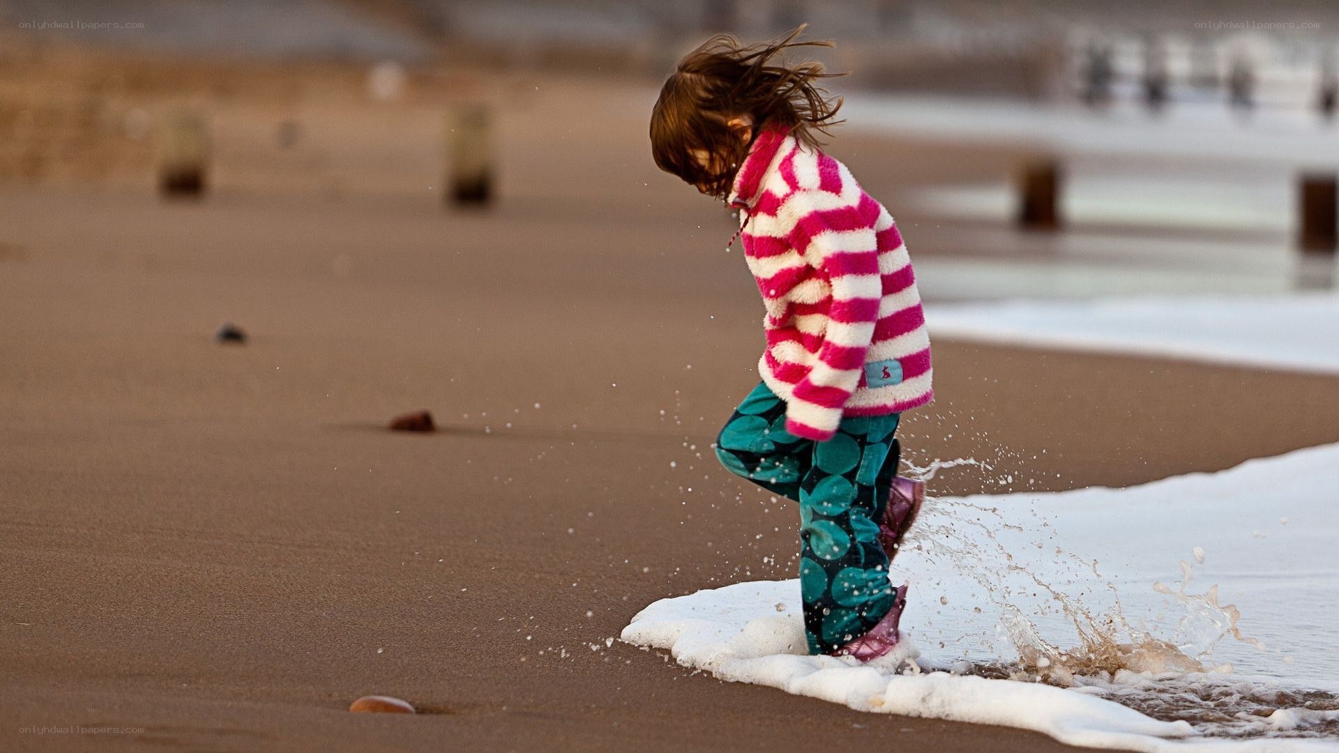 child playing at the beach