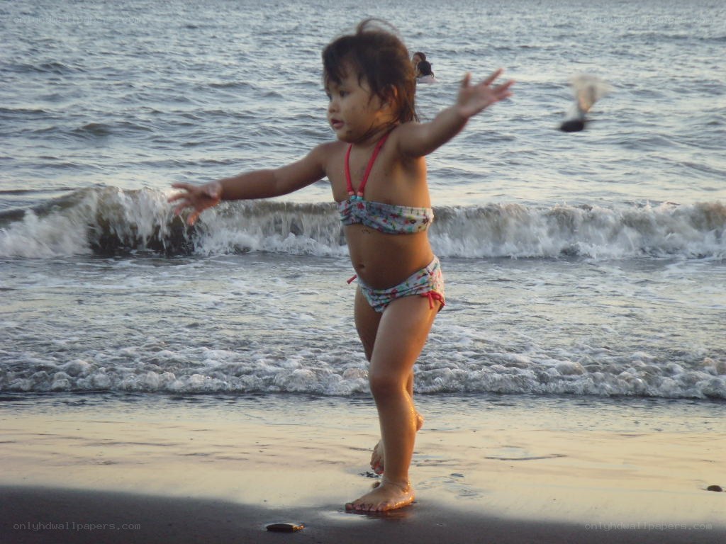 child playing at the beach