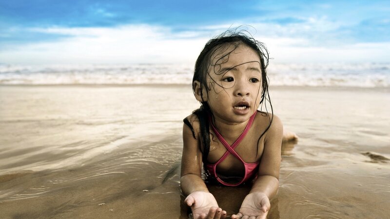 child playing at the beach