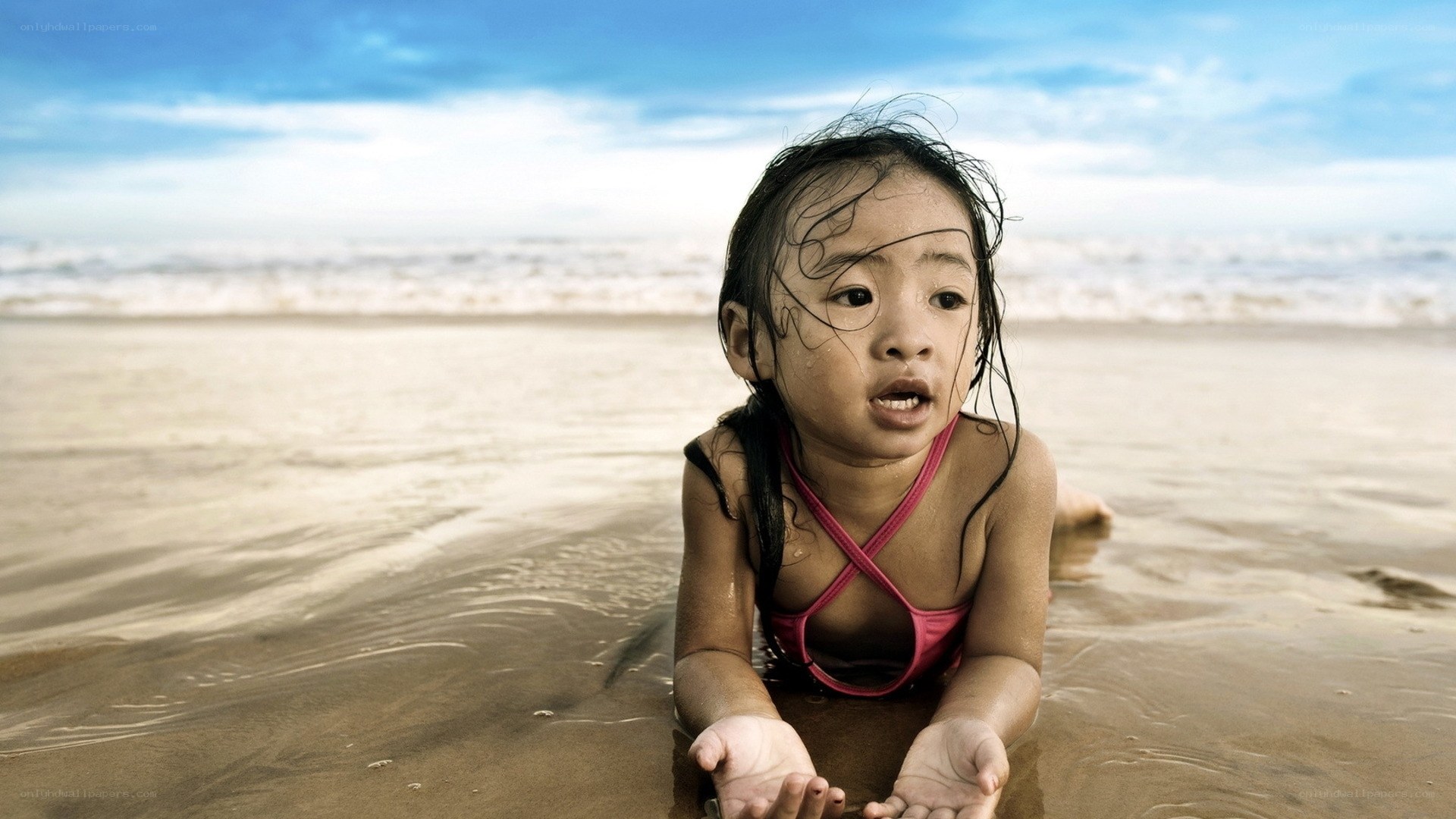 child playing at the beach