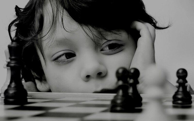 Child Playing Chess — Black