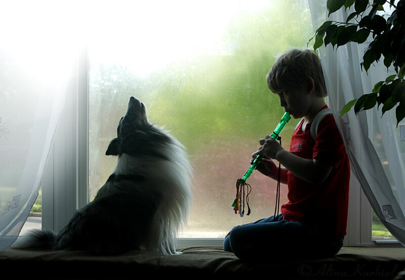 Child Playing Flute with Dog