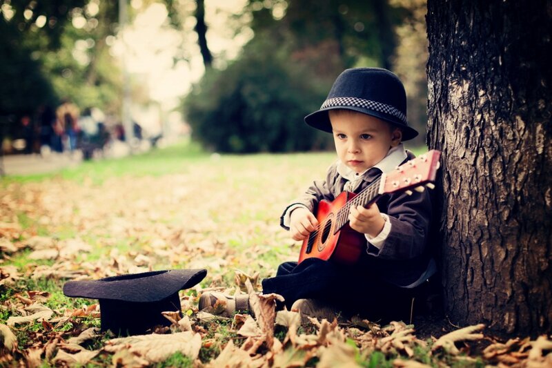 Child Playing Guitar — Brown