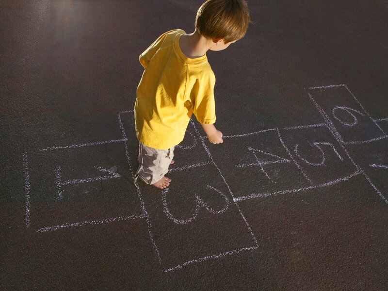 Child Playing Hopscotch — Yellow