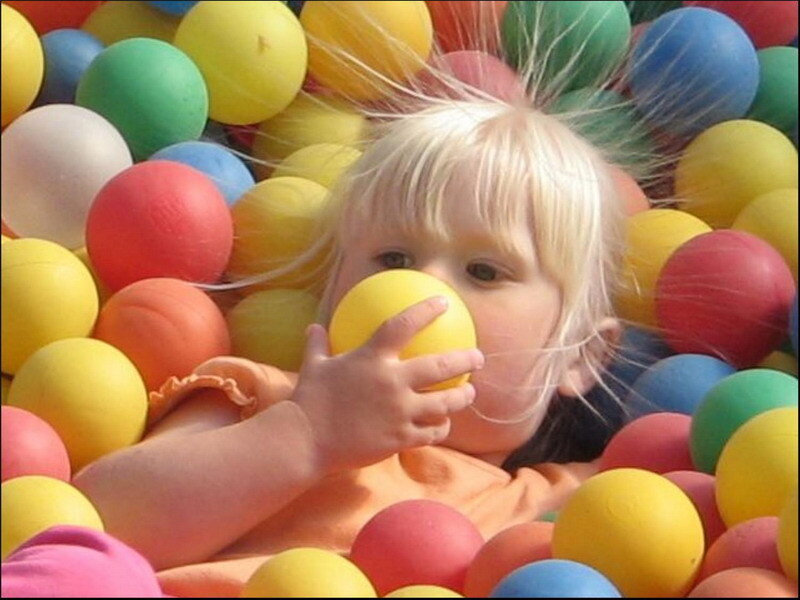 child playing in ball pit