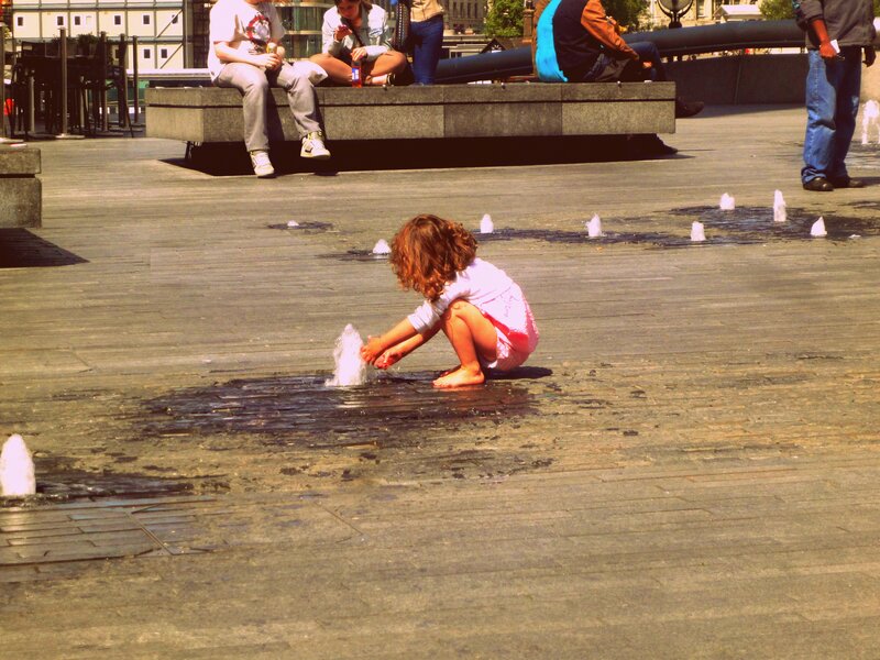 Child Playing in Fountain — Gray, Playful