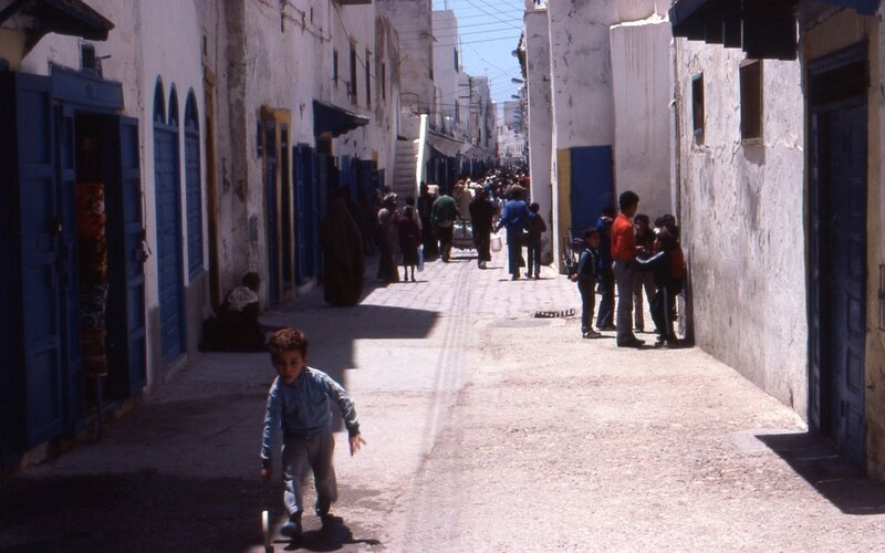 Child playing in narrow alley
