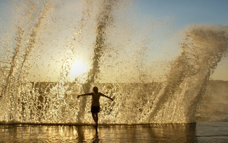 Child playing in ocean waves